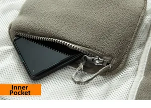 Detail view of the inner zipper pocket on a fleece jacket holding a black smartphone