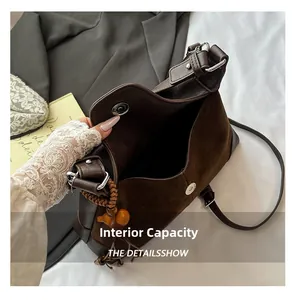 Internal view of dark brown suede hobo bag with magnetic closure and spacious capacity