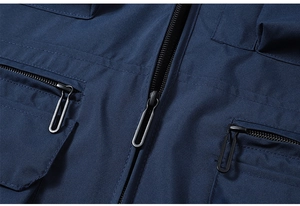 Close-up of durable metal zipper and pocket detail on navy multi-pocket fishing vest