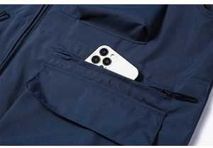 Deep blue multi-pocket outdoor vest showing a large capacity pocket holding a smartphone