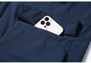 Detail of outdoor fishing vest showing large flap pocket and phone storage capacity