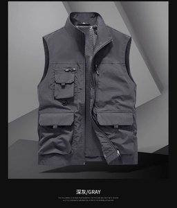 Detail view of dark gray utility vest featuring multiple pockets and breathable mesh lining