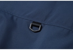 Detail of a black D-ring hook attached with durable nylon webbing on blue outdoor vest