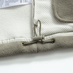 Detail of outdoor fleece hoodie hem with adjustable drawstring and mesh lining