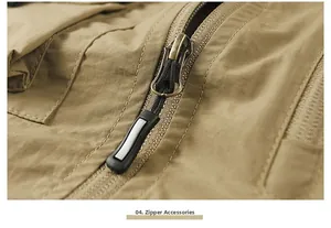 Close-up of a durable metal zipper with black non-slip puller on a khaki tactical vest