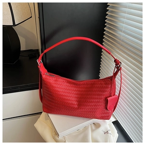 Close-up detail of red woven leather hobo bag with grid pattern and metal zipper closure