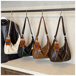Detail of four retro tote bags in neutral colors with cute brown teddy bear charms