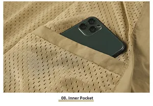 Detail view of khaki work vest interior pocket showing capacity with a smartphone