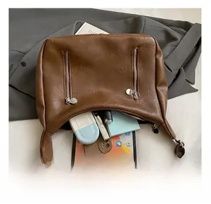 Detail view of brown vintage tote showing large capacity for tablet and cosmetics