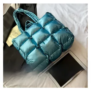 Detail of blue metallic quilted puffer tote bag with large padded checkered design