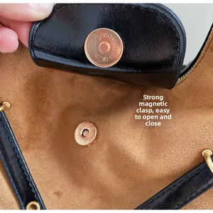 Detail of high-quality strong magnetic buckle and premium brown suede lining on bag