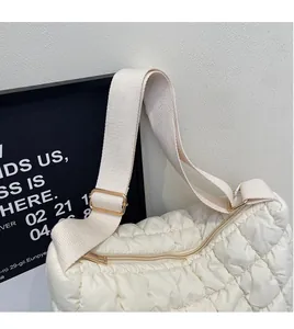 Close-up of quilted cloud bag showing fine stitching and wide adjustable fabric strap