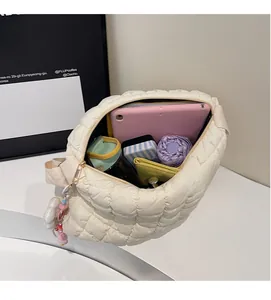 Interior view showing large capacity for tablet, umbrella, and essentials in the quilted bag
