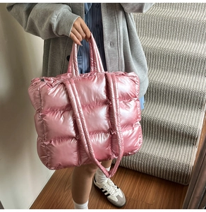 Close-up of pink quilted puffer tote bag with metallic sheen and soft handle details