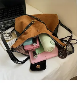 Detailed interior of a brown suede tote bag showing large capacity for laptop and water bottle