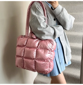 Detail of pink metallic quilted tote bag with glossy finish and square padded stitching