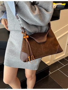 Brown vintage suede hobo bag with fringe tassel and adjustable shoulder strap for women