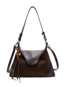 Brown faux suede hobo bag with adjustable strap and decorative tassel charm
