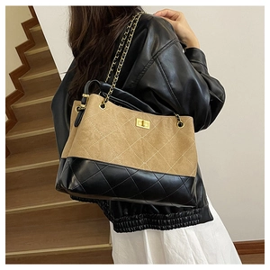 Close-up of quilted tote bag with matte khaki fabric and golden metal lock detail