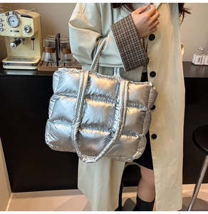 Detailed view of silver quilted puffer tote bag with metallic finish and spacious design