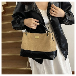 Detail of vintage quilted tote bag with brown matte finish and gold chain strap
