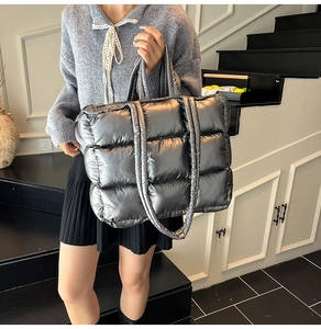 Close-up of metallic silver quilted tote bag with spacious interior and dual straps