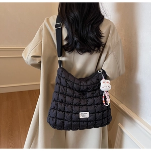 Quilted puffer tote bag with white plush rabbit pendant and logo tag detail