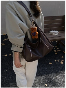 Deep brown matte leather tote bag with stylish metal ring and cute plush bear charm