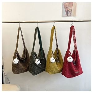 Four textured wool tote bags in brown green yellow and red with monster charms