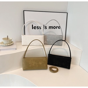 Detailed view of minimalist textured leather shoulder bags in four different colors