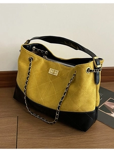 Quilted yellow suede tote bag with black leather base and gold chain strap for women