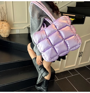 Metallic purple quilted tote bag detail showing puffy texture and glossy finish