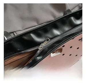 Close-up of pink polka dot tote bag showing silver zipper and premium hardware detail