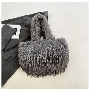 Détail de la texture en fausse fourrure grise et des franges sur un sac fourre-tout chic