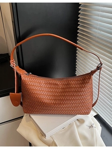 Brown woven leather shoulder bag with Intrecciato pattern and crescent moon shape design