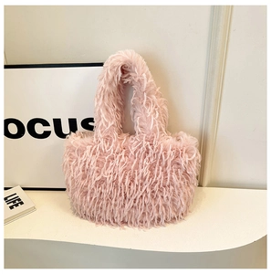 Sac cabas rose en fausse fourrure pelucheuse sur un présentoir blanc minimaliste