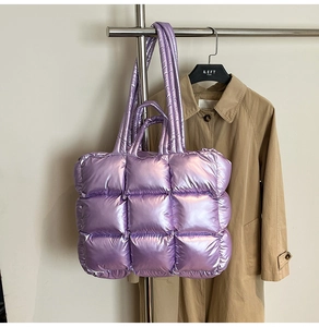 Close-up of quilted purple puffer bag with metallic finish and large square padding