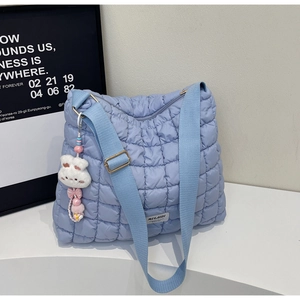 Quilted cloud tote bag detail featuring lavender nylon fabric and plush bunny keychain
