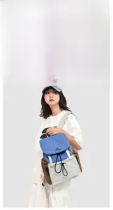 Detail view of the tricolor outdoor backpack with blue flap and grey drawstring pocket