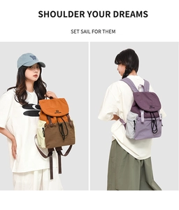 Detailed view of color-block canvas backpack with drawstring closure and buckle flap cover