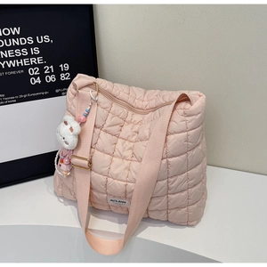 Pink quilted tote bag with white bunny plush charm and adjustable fabric strap detail