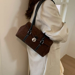 Deep brown suede shoulder bag featuring black leather straps and silver metal buckle lock
