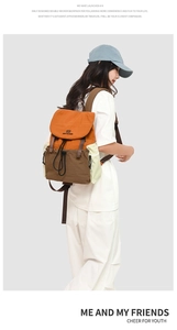 Detail of two-tone casual backpack with orange flap, brown base and drawstring closure