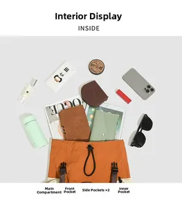 Flat lay of an orange outdoor backpack showing spacious interior storage with multiple pockets