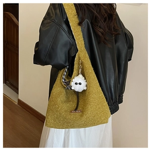 Detail of ginger plush tote bag with lamb wool texture and cute white doll charm