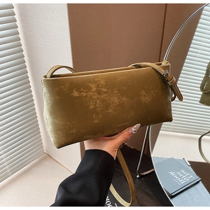 Detail of olive green retro textured shoulder bag with branded CLEAR OK embossing