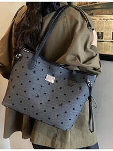 Grey canvas tote bag with black polka dots, bow embroidery, and leather shoulder straps