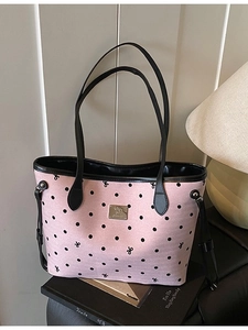 Pink polka dot canvas tote bag with black bow print and leather shoulder straps