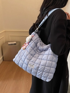 Quilted padded tote bag in light blue with bead and plush rabbit charms on shoulder strap