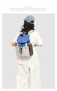 Detail showing the multicolor block design and drawstring closure of this travel backpack